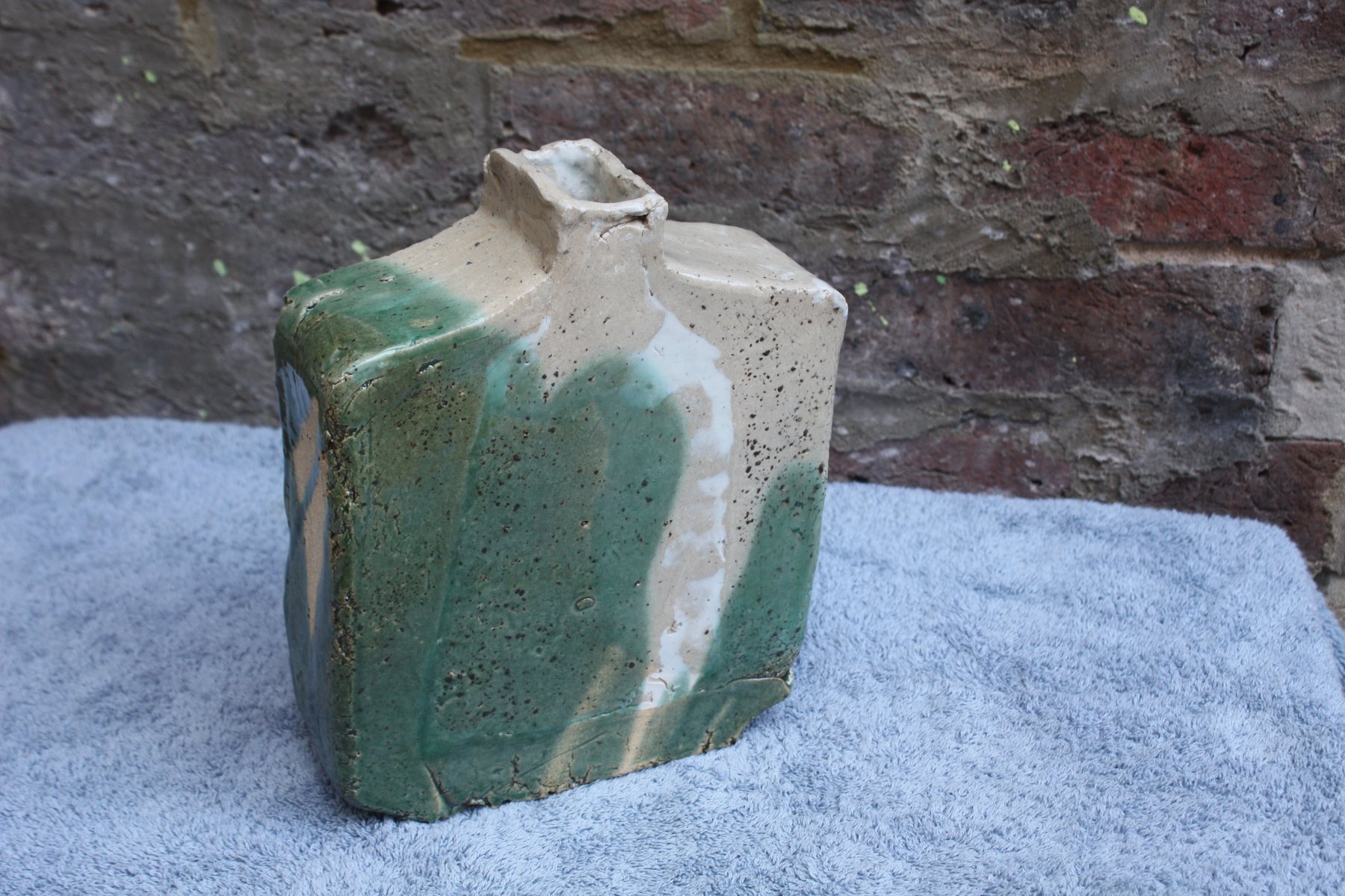Slab-built ceramic bottle with cream clay and a pour of sage-green glaze by Graham Matthews