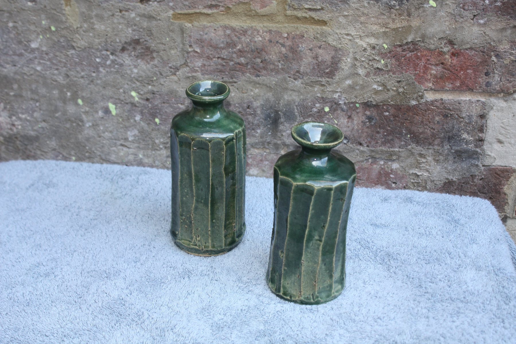 Pair of faceted green vases by Graham Matthews