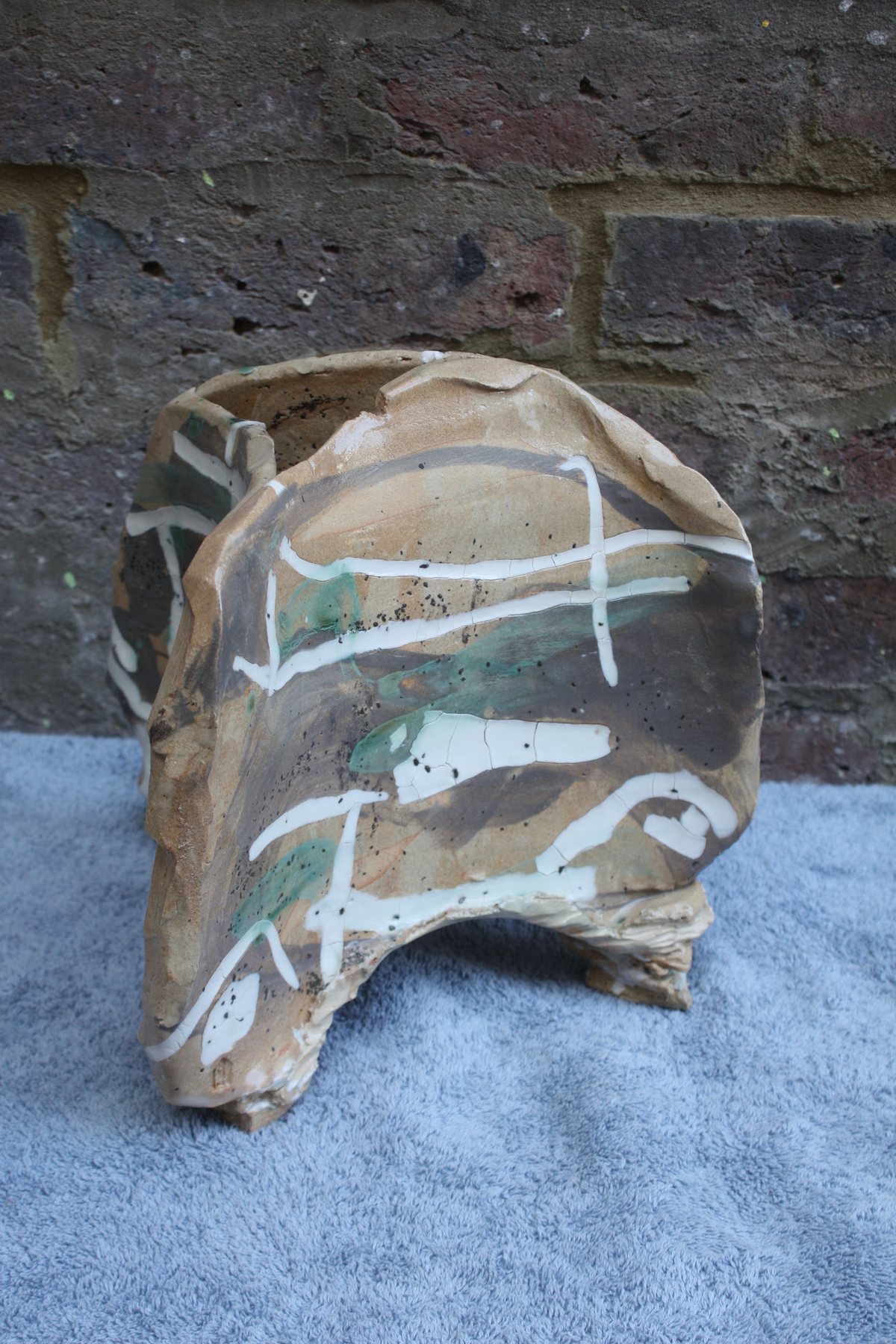 Folded sculptural ceramic vessel with white calligraphic marks by Graham Matthews